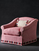 Pink upholstered skirt armchair trimmed with Pop Art Border in Berry by Kit Kemp, featuring matching embroidered cushion. Interior design by Susie Atkinson.